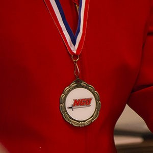 Athlete wearing Hall of Fame medal around neck.