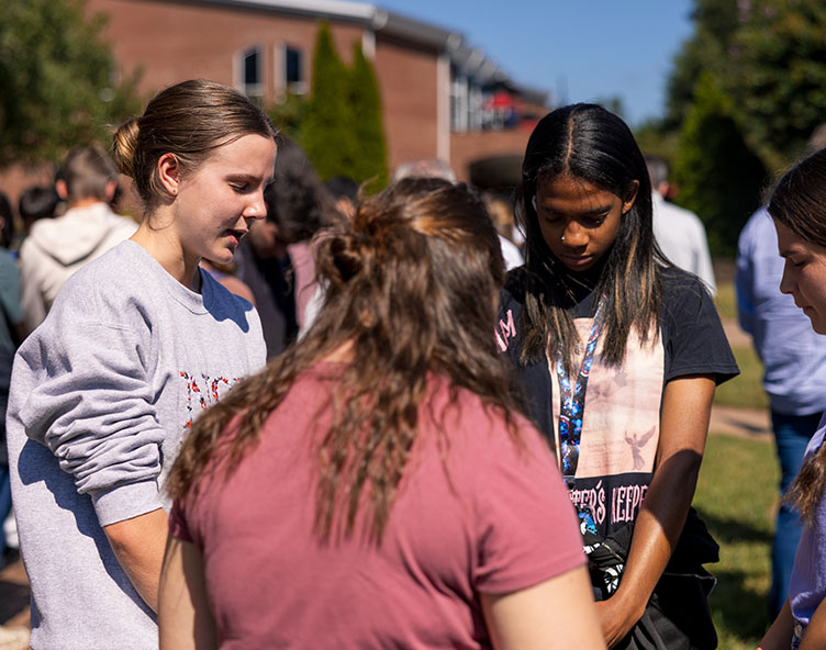 students praying on campus
