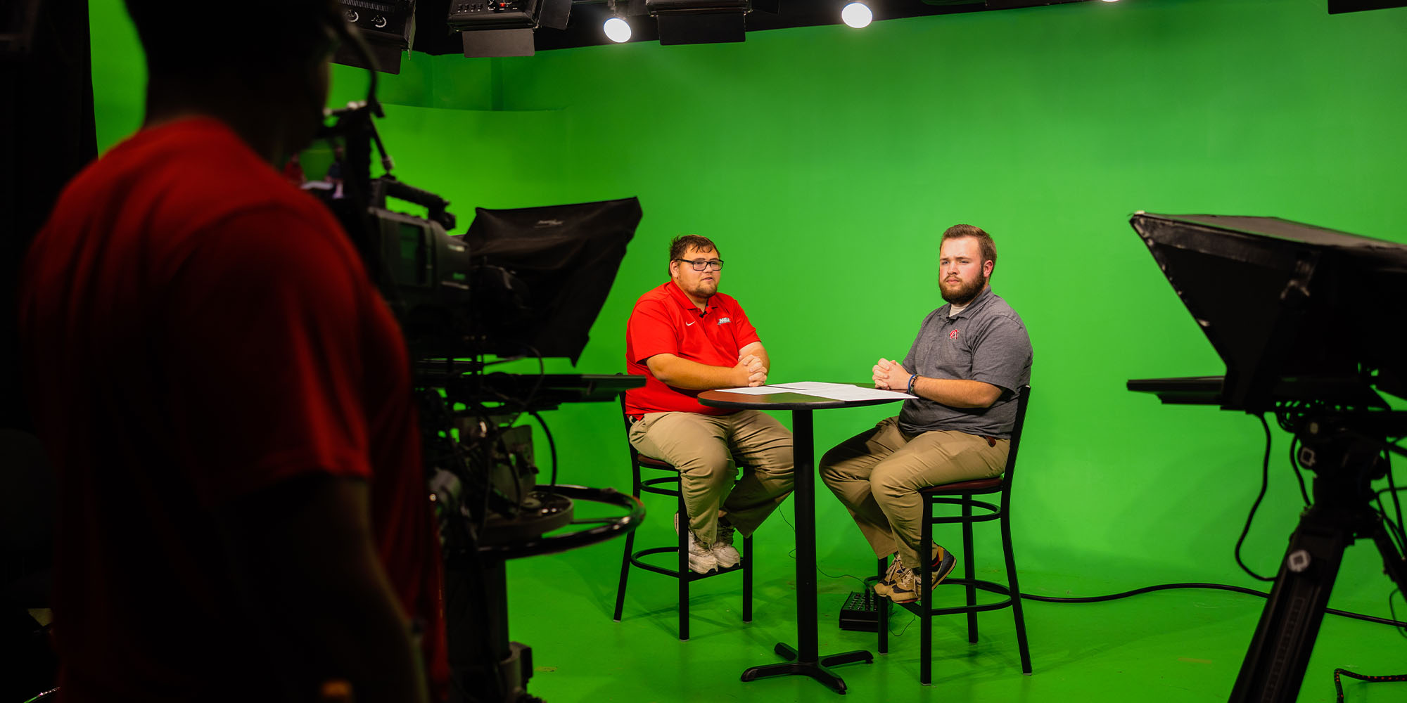 students working inside a broadcast studio