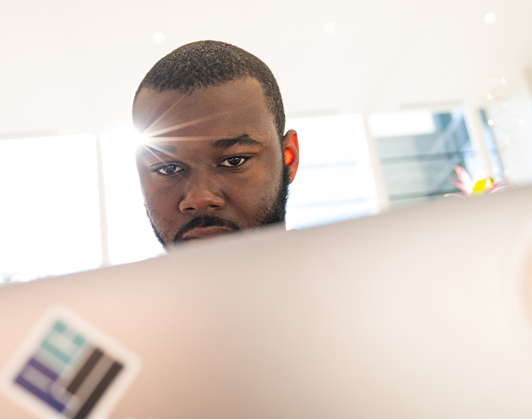 student working on laptop in coffee shop