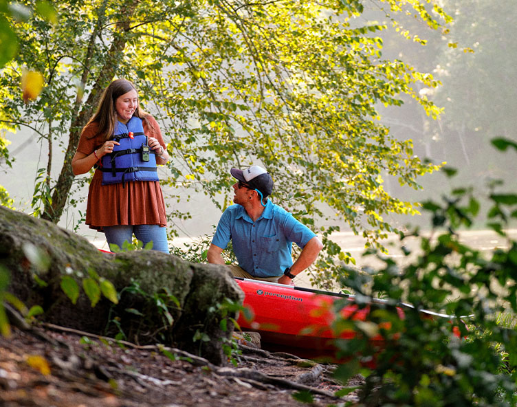 student being taught how to use a canoe
