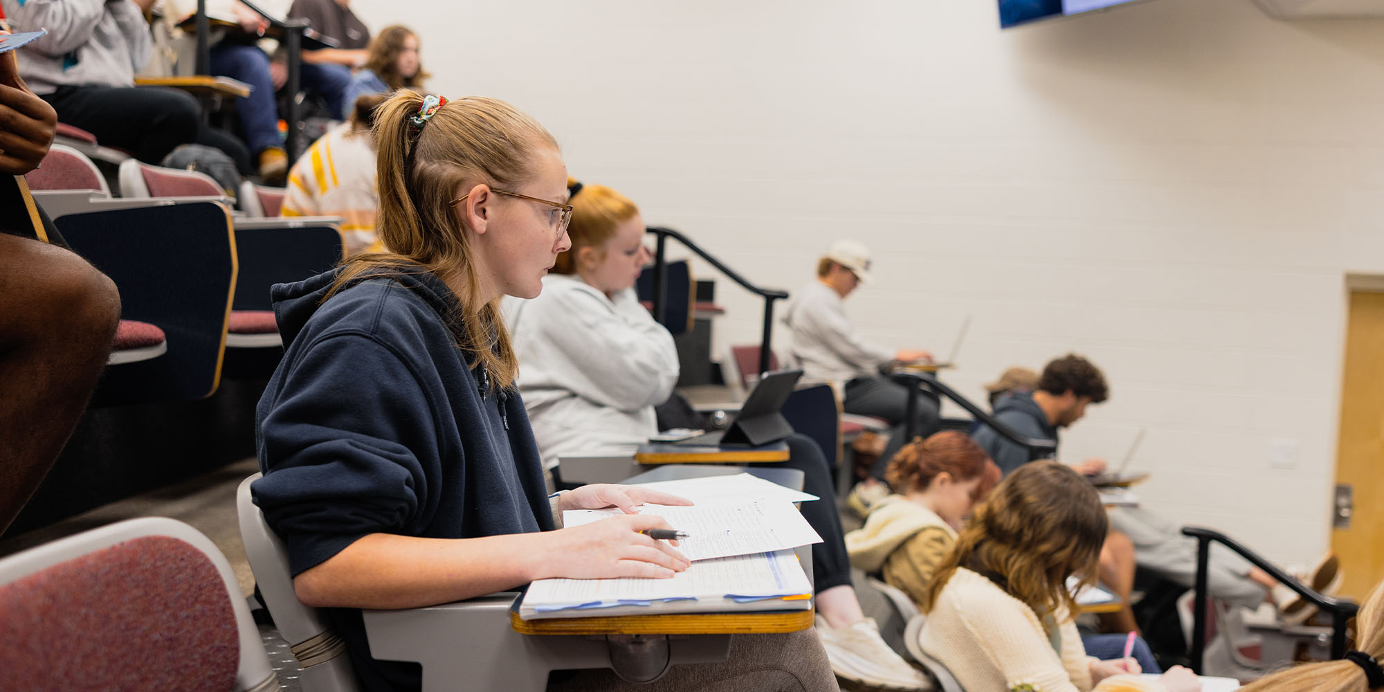 student studying in classrooom during class