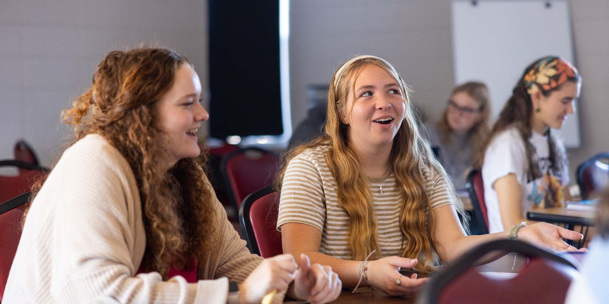 girls chatting in a classroom