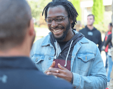 Black male student happy with others