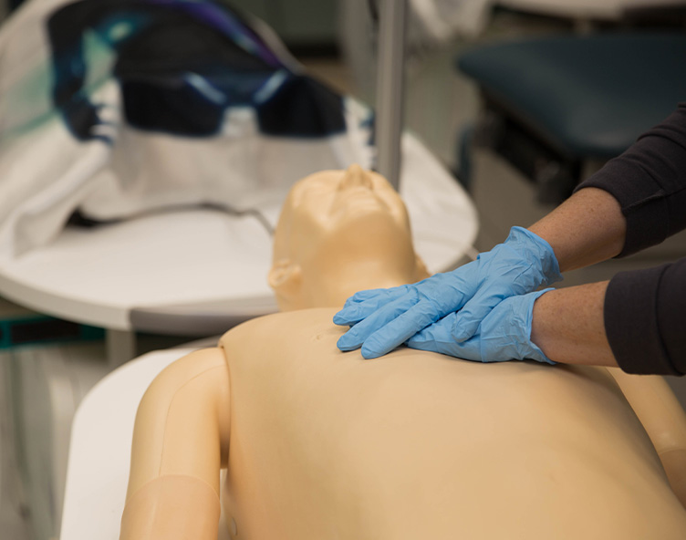 Student performing cpr on a dummy