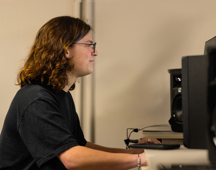 student at a desktop computer