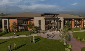 A full front-view of the new Donnan Administration and COBE building with students walking in the courtyard.