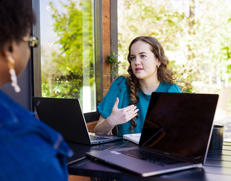 online students talking at a table