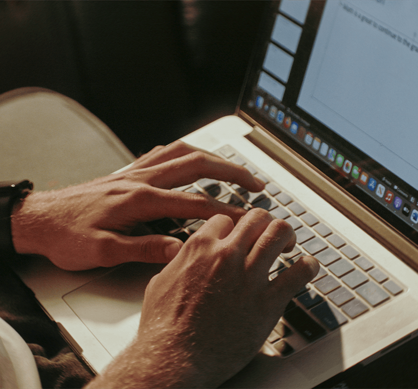 someone typing on a laptop computer