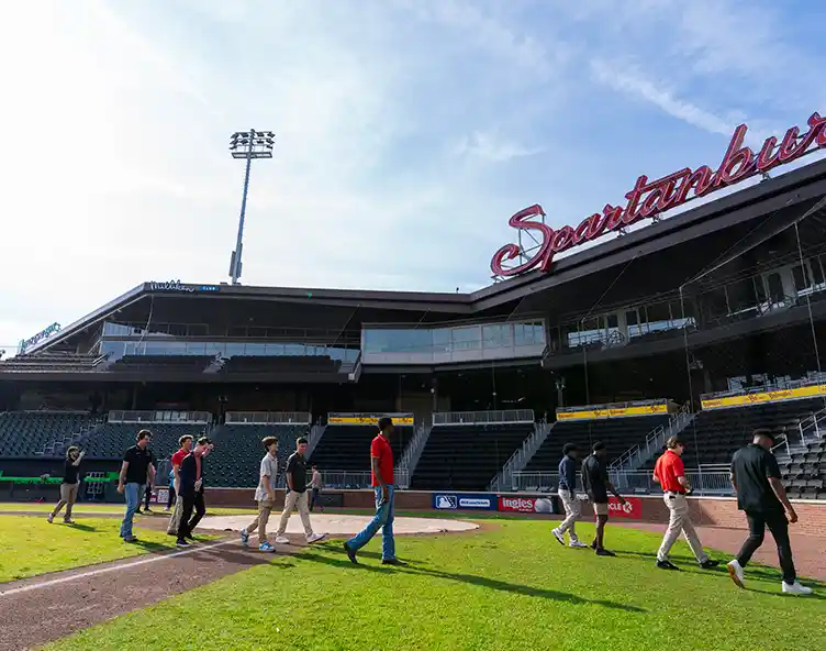 students walking across baseball field