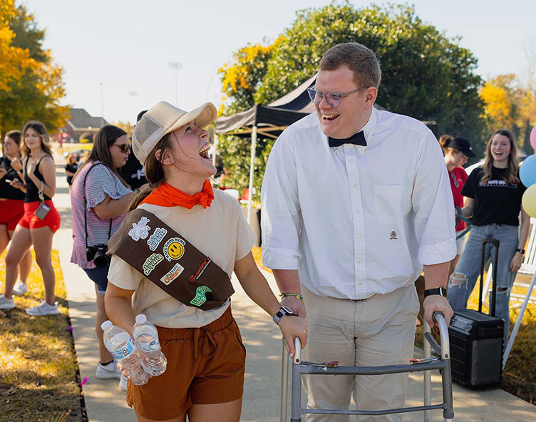 girl walking with her father through campus